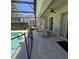 View of screened in pool area with table and chairs and doors to the house at 160 Calabay Parc Blvd, Davenport, FL 33897