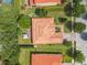 Overhead view showcases a home's tile roof, backyard gazebo, and lush landscaping within a well-maintained neighborhood at 169 Verde Way, Debary, FL 32713