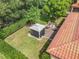 Aerial view of a private backyard featuring a patio with a fire pit and gazebo surrounded by well-manicured landscaping at 169 Verde Way, Debary, FL 32713