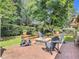 Charming brick patio features a stone fire pit and Adirondack chairs, perfect for outdoor entertaining and relaxation at 169 Verde Way, Debary, FL 32713