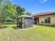 Landscaped backyard featuring a gazebo, outdoor grill, and manicured lawn at 169 Verde Way, Debary, FL 32713