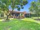 Expansive backyard with lush green grass, screened patio, and gazebo offers a serene outdoor living space at 169 Verde Way, Debary, FL 32713