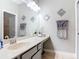 Bathroom featuring single vanity, large mirror, neutral walls, and tiled floors at 169 Verde Way, Debary, FL 32713