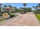 Gated community entrance with lush landscaping, brick-paved road, and security kiosk for controlled access at 169 Verde Way, Debary, FL 32713