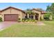 Charming one-story home with a well-manicured lawn, tile roof, and inviting front entrance at 169 Verde Way, Debary, FL 32713