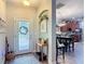 Bright foyer with decorative rug, table, and wreath, leading to an open-concept living space at 169 Verde Way, Debary, FL 32713