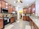 Well-appointed kitchen with stainless steel appliances, granite countertops, and wood cabinets at 169 Verde Way, Debary, FL 32713