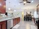 Open kitchen and dining area features granite counters, wood cabinets, and stainless steel appliances at 169 Verde Way, Debary, FL 32713