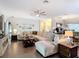 Open-concept living room with comfortable seating, hardwood floors, and stylish decor at 169 Verde Way, Debary, FL 32713