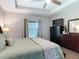 Well-lit bedroom features a ceiling fan, tray ceiling, and large windows for ample natural light at 169 Verde Way, Debary, FL 32713