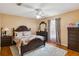 Cozy bedroom with a decorative bed frame, dresser, and patterned rug on tile floor at 176 Hidden View Dr, Groveland, FL 34736