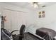 Inviting bedroom with white walls, ceiling fan, and a full wall of built in closet space at 176 Hidden View Dr, Groveland, FL 34736