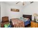 Comfortable bedroom with ceiling fan, natural light from window, and chair at 176 Hidden View Dr, Groveland, FL 34736
