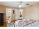 Bedroom with ceiling fan, tile floors, connecting doors to the dining room and bathroom at 176 Hidden View Dr, Groveland, FL 34736