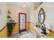 Inviting foyer with decorative mirror, a tiled floor, and a striking red front door at 176 Hidden View Dr, Groveland, FL 34736