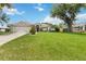 Charming single-story home featuring a lush green lawn, two car garage, and mature landscaping at 176 Hidden View Dr, Groveland, FL 34736