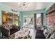 Bright living room with sliding glass doors to the backyard and two stylish sofas at 176 Hidden View Dr, Groveland, FL 34736