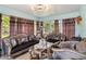 Living room with patterned sofas, decorative curtains, and lots of natural light at 176 Hidden View Dr, Groveland, FL 34736