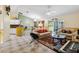 Open floor plan showcases the living room, kitchen, and dining area with an elegant chandelier at 176 Hidden View Dr, Groveland, FL 34736