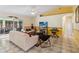 Bright living room with tile floors, ceiling fan, comfortable seating, and sliding glass doors at 176 Hidden View Dr, Groveland, FL 34736