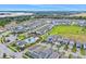 Aerial view of a residential neighborhood with community pool and scenic lake views at 1787 White Feather Loop, Oakland, FL 34787