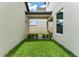Landscaped backyard featuring green lawn, pathway, privacy fence, and outdoor seating area at 1787 White Feather Loop, Oakland, FL 34787