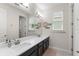 Bathroom featuring double sinks with countertop space and a large mirror at 1787 White Feather Loop, Oakland, FL 34787