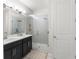 Modern bathroom featuring double vanity and a spacious glass enclosed shower with rainfall showerhead at 1787 White Feather Loop, Oakland, FL 34787