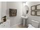 Elegant powder room featuring stylish decor and a pedestal sink at 1787 White Feather Loop, Oakland, FL 34787