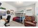 Cozy bedroom featuring a bunk bed, desk with computer, and a comfortable armchair at 1787 White Feather Loop, Oakland, FL 34787