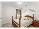 Cozy bedroom featuring a wooden four poster bed, neutral tones, and a decorative wall piece at 1787 White Feather Loop, Oakland, FL 34787