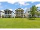 Charming two-story home featuring a well-maintained lawn and inviting double balconies at 1787 White Feather Loop, Oakland, FL 34787