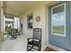 Inviting front porch with rocking chair and seating, perfect for relaxing outdoors at 1787 White Feather Loop, Oakland, FL 34787