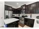 Modern kitchen featuring sleek cabinetry, stainless steel appliances, and a center island at 1787 White Feather Loop, Oakland, FL 34787