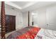 Comfortable main bedroom features a four poster bed and ensuite bathroom at 1787 White Feather Loop, Oakland, FL 34787