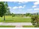 Scenic view of a well-maintained neighborhood park with mature trees and walking paths at 1787 White Feather Loop, Oakland, FL 34787