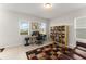 Bright office space featuring a bookshelf and large windows offering natural light at 1787 White Feather Loop, Oakland, FL 34787