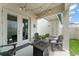 Inviting covered patio with string lights, Adirondack chairs, and a modern fire pit at 1787 White Feather Loop, Oakland, FL 34787