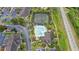 Community aerial view with swimming pool, tennis courts, and lush landscaping at 1910 Summer Club Dr # 108, Oviedo, FL 32765