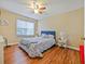Bright bedroom with a window view, light walls and hardwood floors at 1910 Summer Club Dr # 108, Oviedo, FL 32765