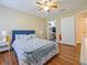 Bedroom featuring a queen-sized bed, wood flooring, and closet space at 1910 Summer Club Dr # 108, Oviedo, FL 32765
