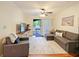 Comfortable living room with sliding doors to the balcony, ceiling fan, and neutral tones at 1910 Summer Club Dr # 108, Oviedo, FL 32765
