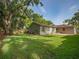 Expansive backyard featuring a lush lawn and mature trees at 2100 Forest Cir, Orlando, FL 32803