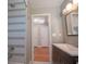 Bathroom featuring updated vanity, and tiled shower, enhanced by ample lighting at 2100 Forest Cir, Orlando, FL 32803