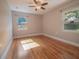 Bedroom with hardwood floors, windows offering natural light, and a ceiling fan at 2100 Forest Cir, Orlando, FL 32803