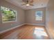 Bedroom with hardwood floors, windows offering natural light, and a ceiling fan at 2100 Forest Cir, Orlando, FL 32803