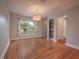 Empty dining room boasting hardwood floors, modern chandelier, and lots of natural light at 2100 Forest Cir, Orlando, FL 32803