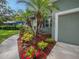 Exterior featuring a well landscaped yard, colorful flowers, and palm trees at 2100 Forest Cir, Orlando, FL 32803