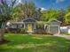 Charming house featuring a well-manicured lawn and colorful flowers at 2100 Forest Cir, Orlando, FL 32803