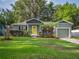Charming single-story home with a well-manicured lawn and colorful front yard landscaping at 2100 Forest Cir, Orlando, FL 32803